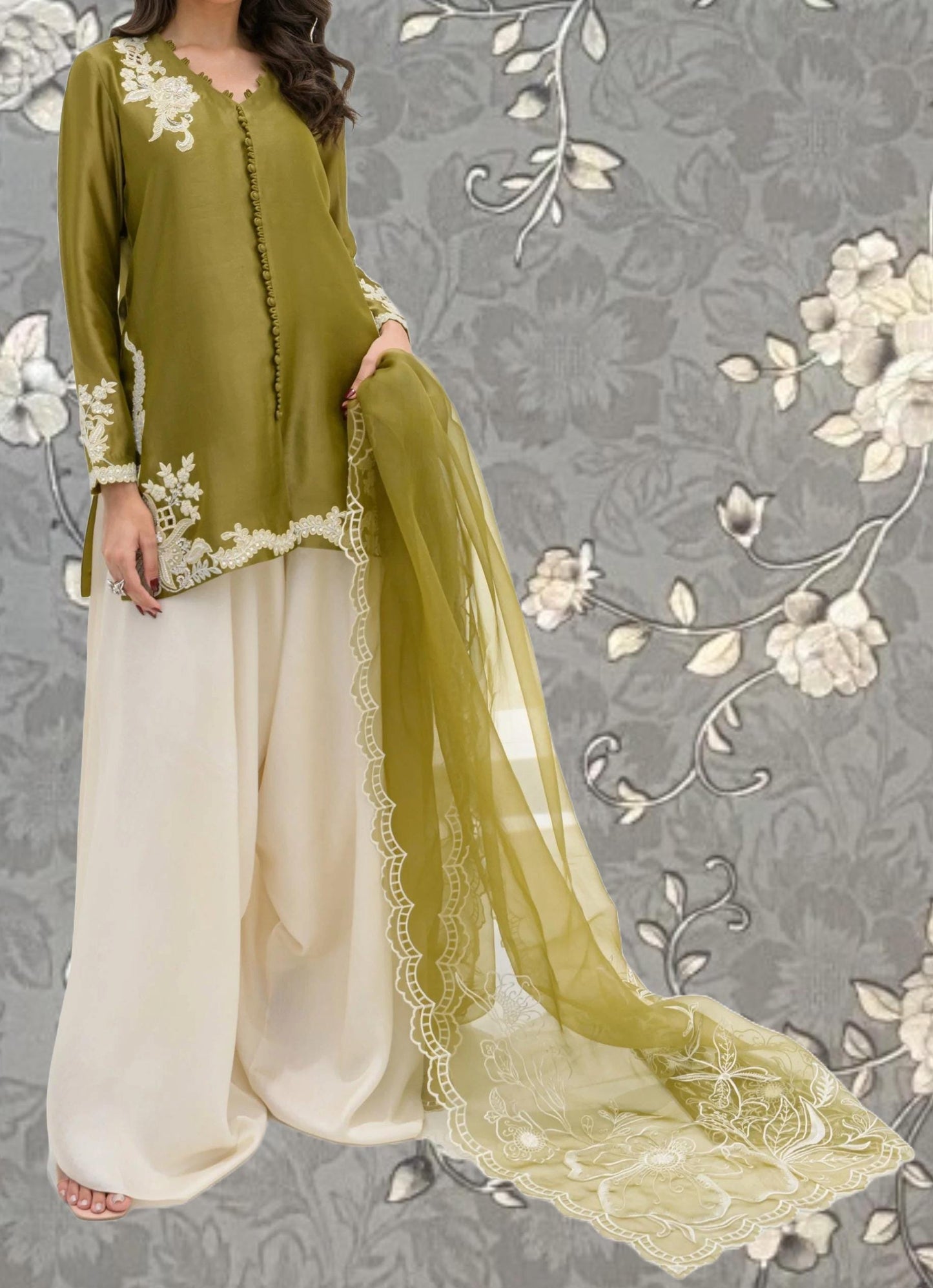 A woman wearing a green and white dress with a long, flowing skirt and a matching green shawl.