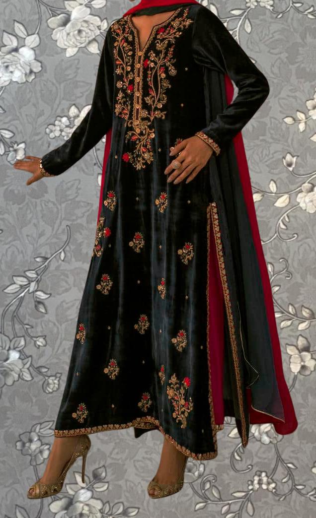 A black and red embroidered dress with a red shawl draped over the shoulders, worn by a person.