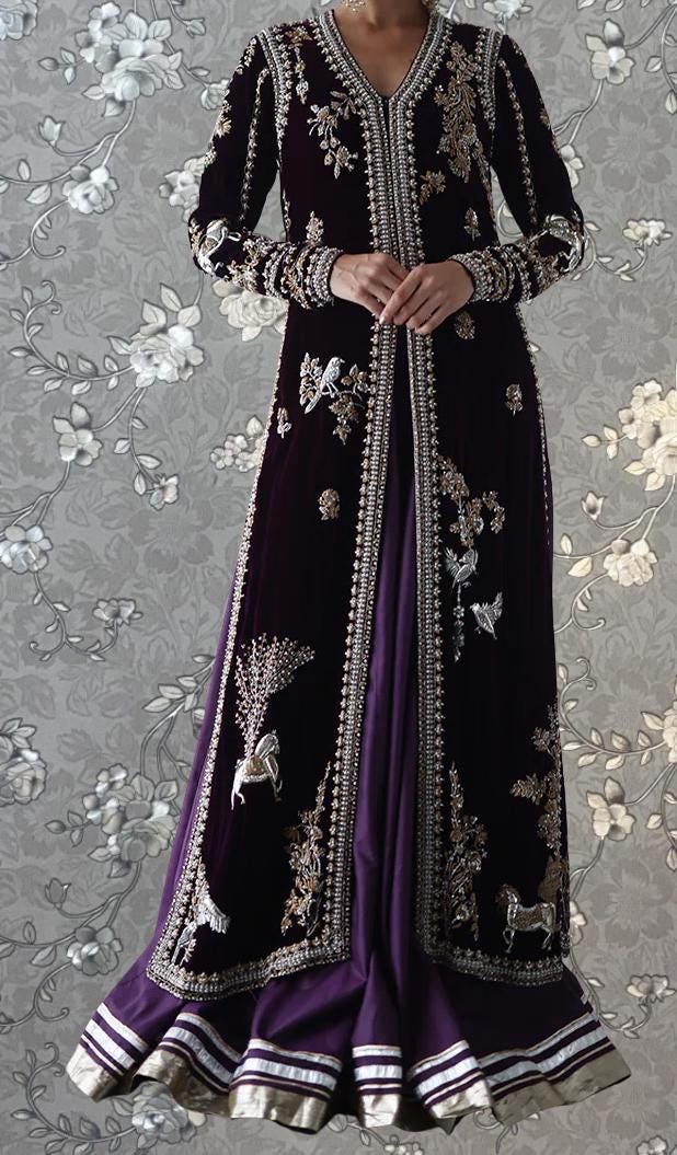 A woman wearing an ornate, purple and gold embroidered dress with a long, flowing skirt.