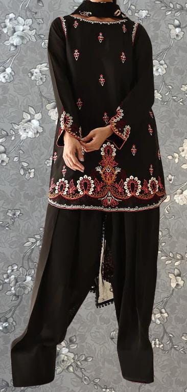 A person wearing a black dress with intricate embroidered patterns and designs.
