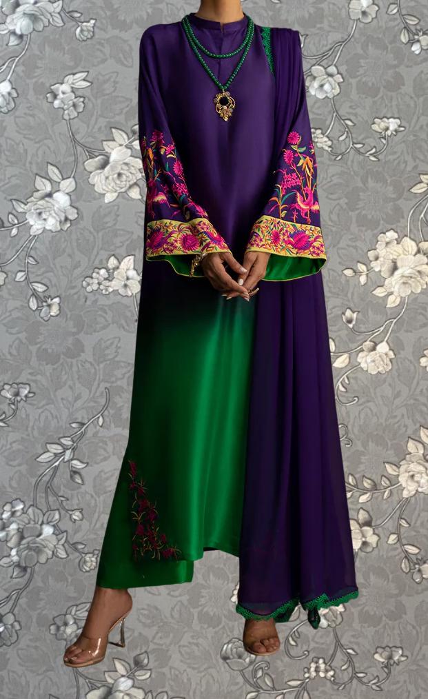 A person wearing a long purple dress with green sleeves and a matching green skirt, accessorized with a necklace and high heels.