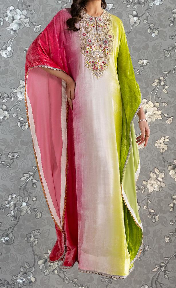 A woman wearing a colorful, patterned dress with a mix of pink, green, and white colors.