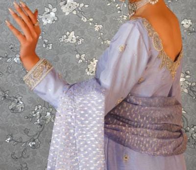 A woman wearing a purple dress with gold embroidery and a matching scarf is shown in the image.