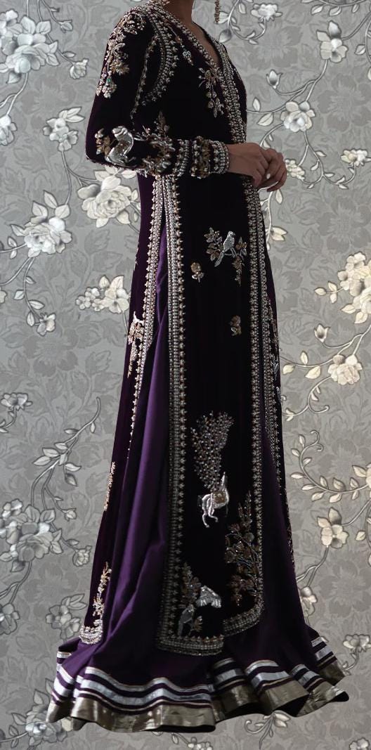 A woman wearing a long, purple dress with intricate embroidery and floral patterns.