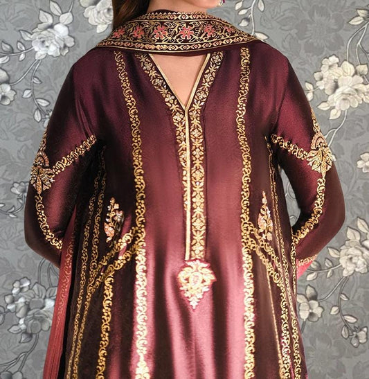 a close-up view of a person wearing a long, burgundy dress with intricate gold embroidery and patterns. The dress features a high collar and long sleeves, giving it a formal and elegant appearance.