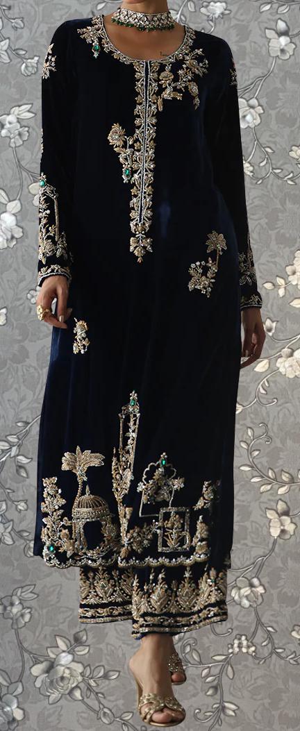 A woman wearing a long, black dress with intricate gold embroidery and floral designs.