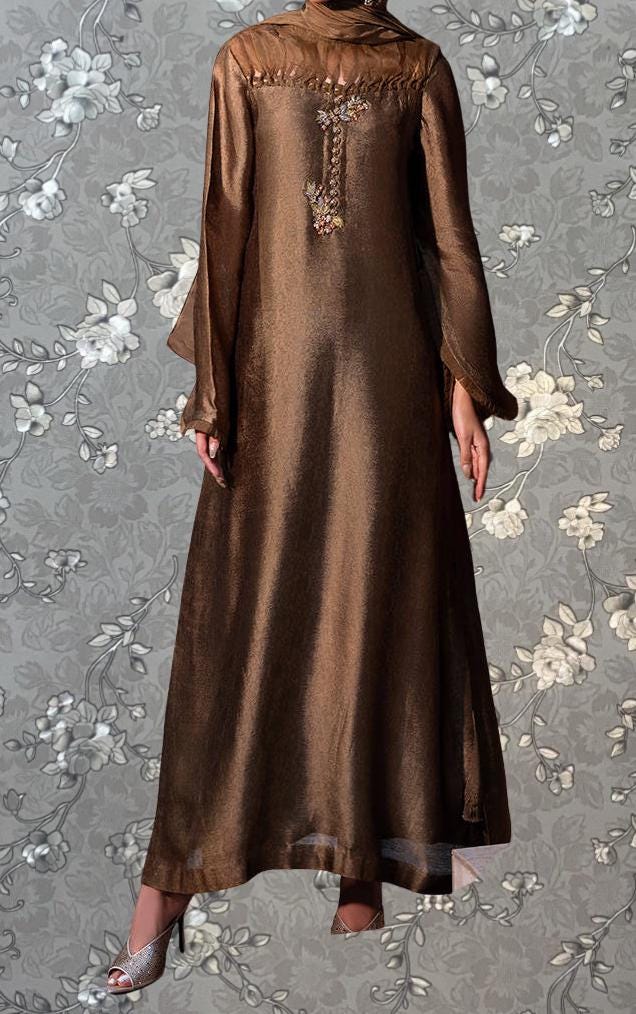 A brown, long dress with a floral pattern on the background.