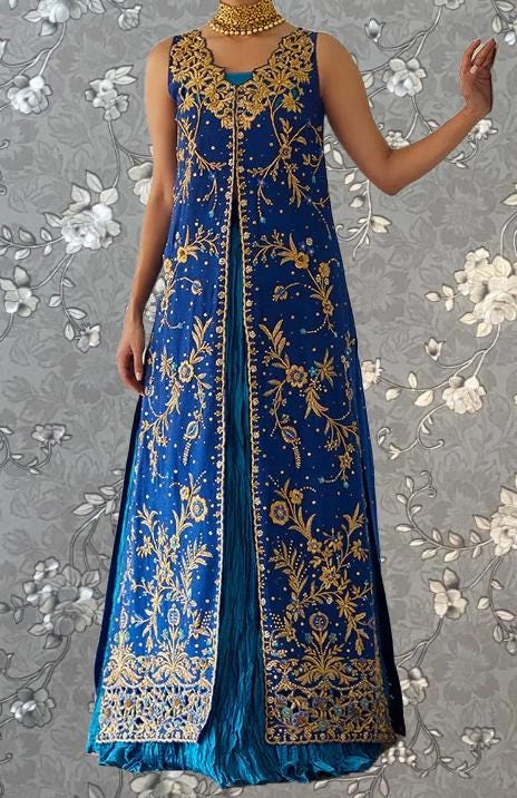A woman wearing a long, blue dress with gold embroidery and a high neckline.