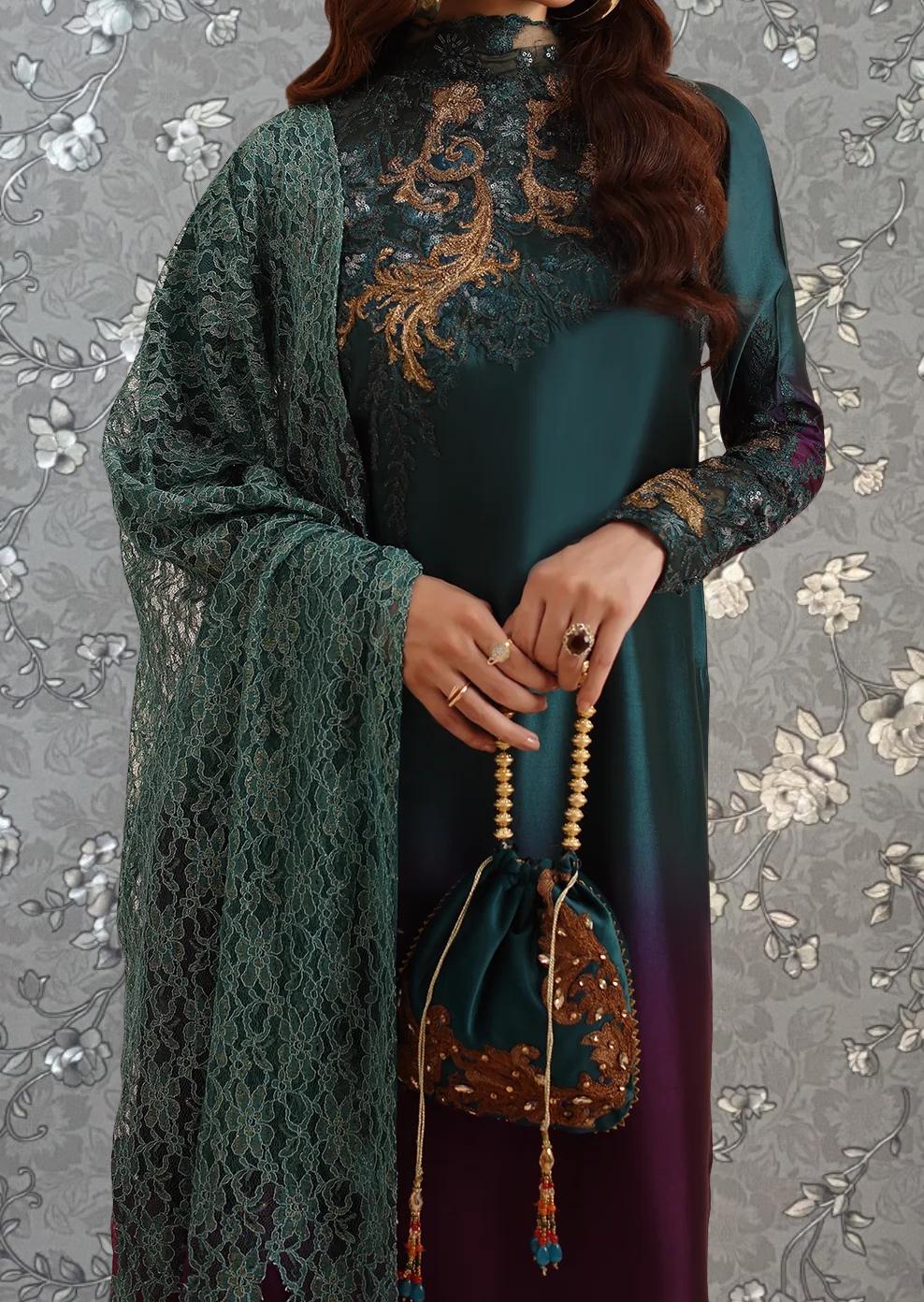 A woman wearing a green and gold dress with a lace shawl draped over her shoulders, holding a small purse with a tassel.