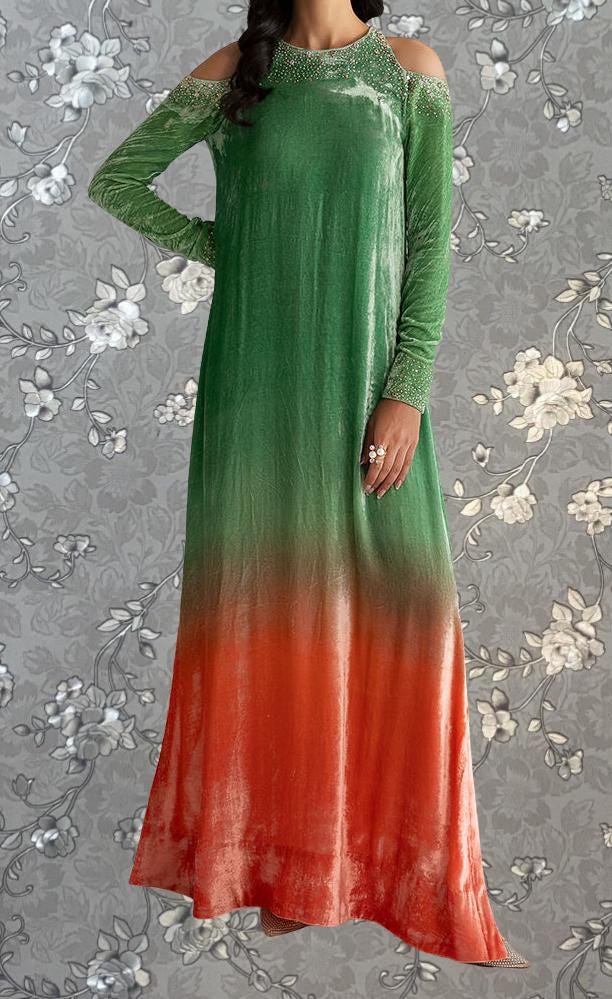 A woman wearing a long, green dress with a gradient of colors, featuring a floral pattern on the background.