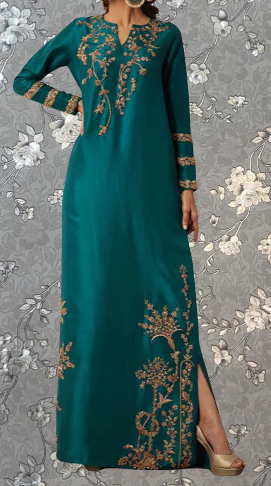 A woman wearing a long, teal-colored dress with gold embroidered patterns on the sleeves and hem.