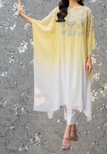 A woman wearing a yellow and white dress with intricate embroidery stands against a gray floral background.