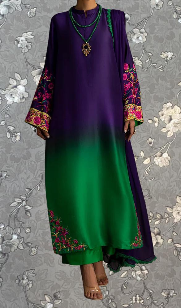 A person wearing a long purple dress with green accents, including embroidered patterns and a matching green and purple scarf draped over the shoulder.