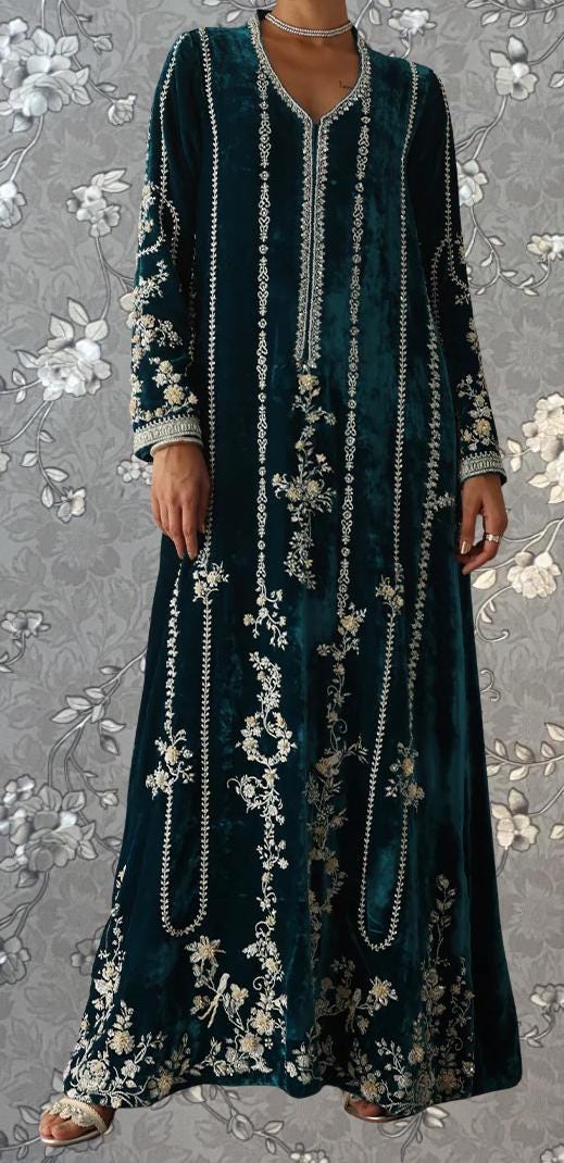 A long, ornately embroidered dress in a dark green color, with intricate floral patterns and designs. The dress has a high neckline and long sleeves, giving it a formal and elegant appearance.