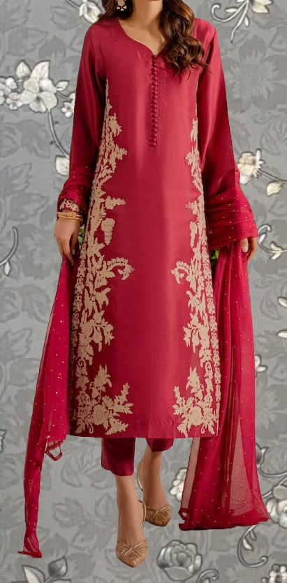 A woman wearing a red dress with gold embroidery stands against a gray floral background.