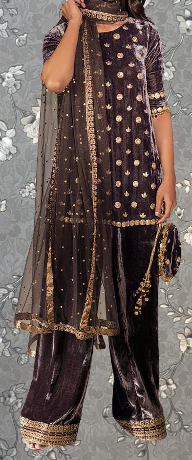 A person wearing a purple velvet dress with gold polka dots and a matching shawl.