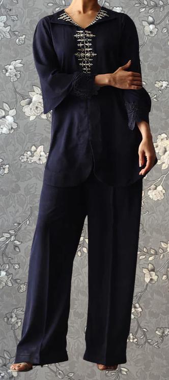 A person wearing a navy blue outfit with a floral pattern on the top and bottom.