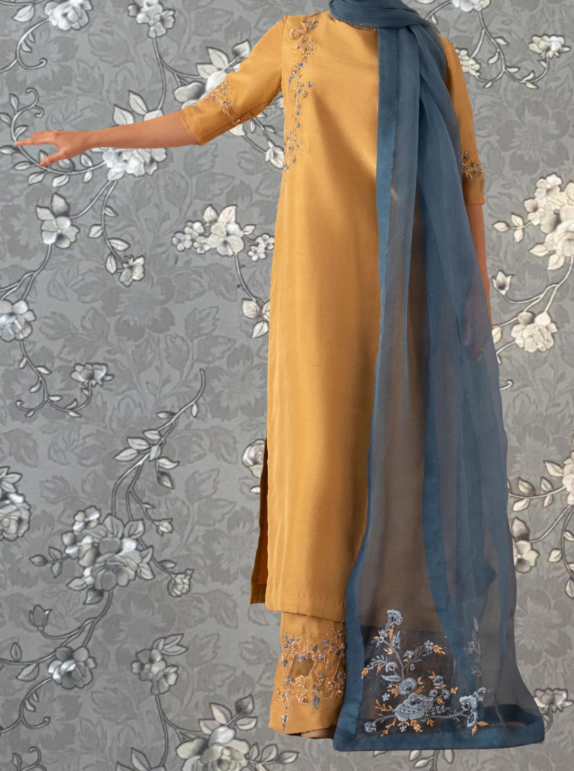 a person wearing a yellow dress with a blue scarf draped over their shoulder.