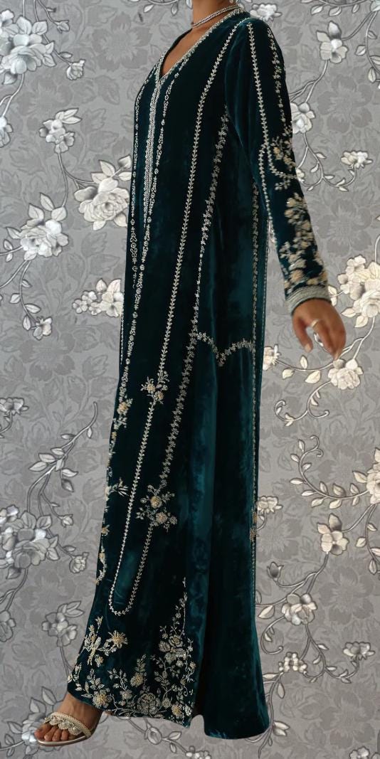 A long, dark green velvet dress with intricate embroidered patterns and designs.