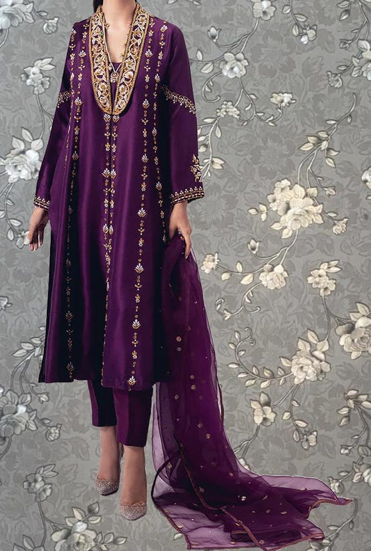 A person wearing a long purple dress with gold embroidery and a matching purple shawl.