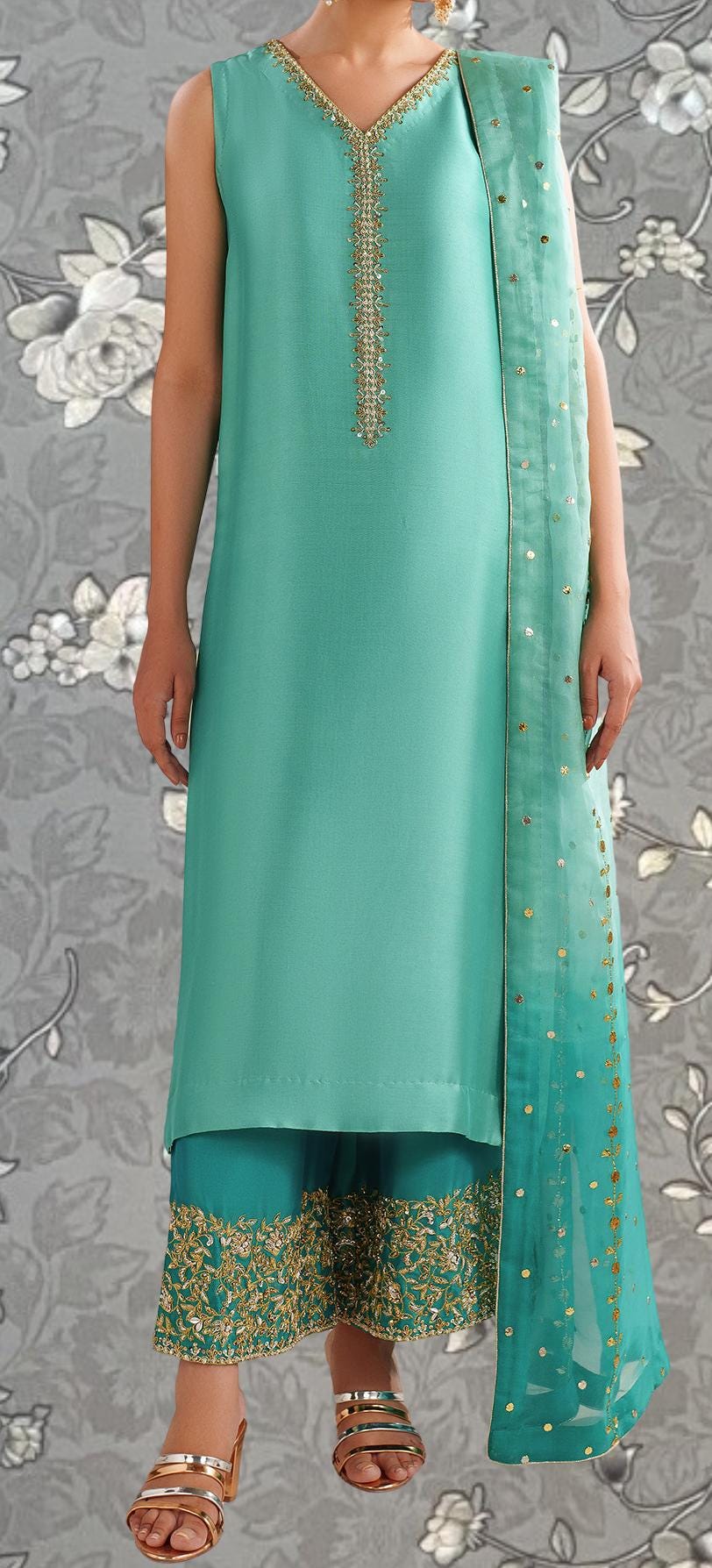 A woman wearing a turquoise dress with gold embroidery and a matching turquoise shawl.