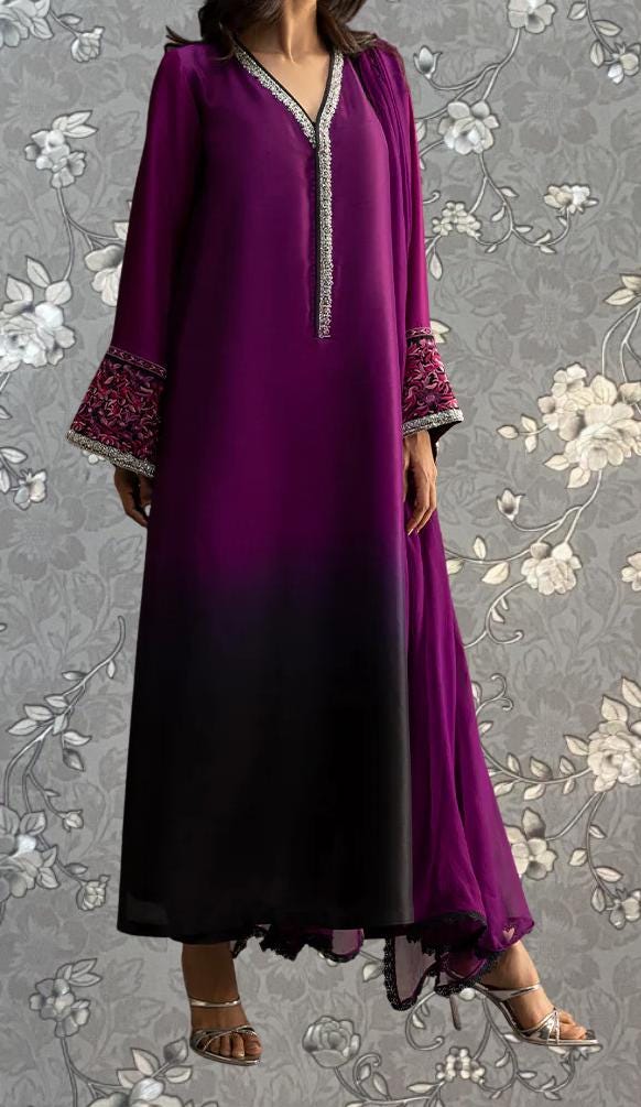 A woman wearing a long purple dress with a black and purple patterned design on the sleeves and a matching purple skirt.
