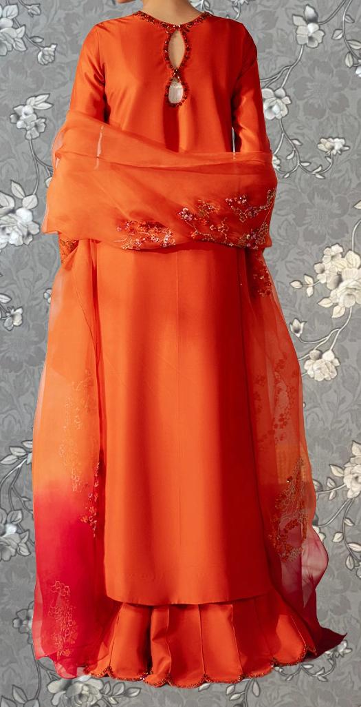 A bright orange dress with a floral pattern on the sleeves and skirt, displayed against a gray floral background.