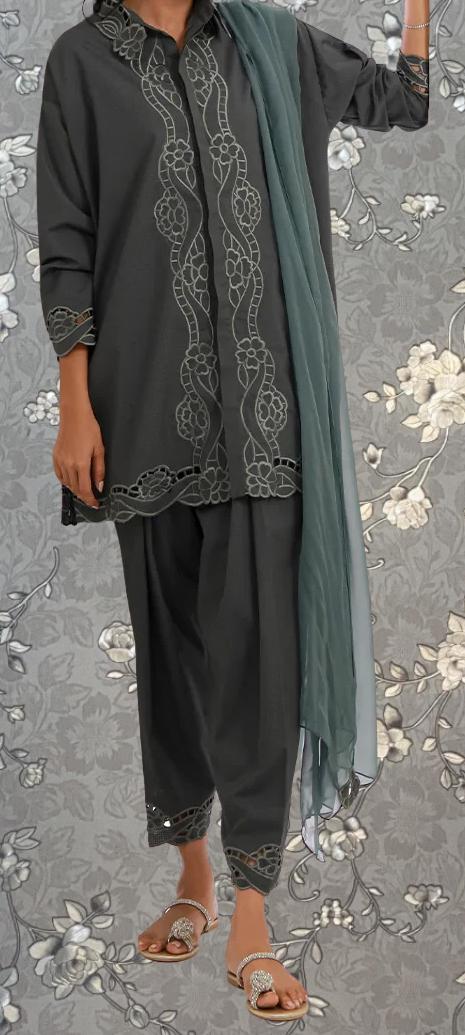 A person wearing a gray dress with intricate embroidered patterns and a matching gray scarf.