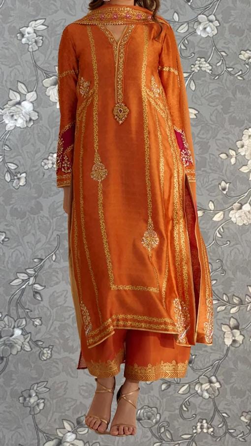 a woman wearing an orange and gold dress with intricate embroidery and patterns.