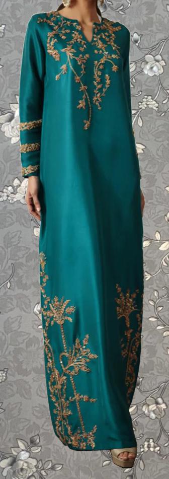 A woman wearing a long, teal-colored dress with gold embroidered patterns on the bodice and sleeves.