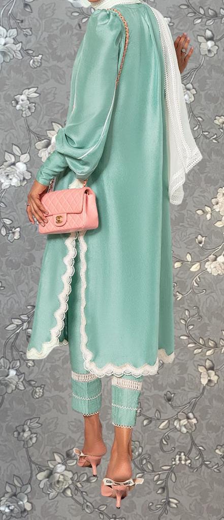 A woman wearing a mint green dress with lace trim, holding a pink handbag, and wearing high heels against a gray floral background.