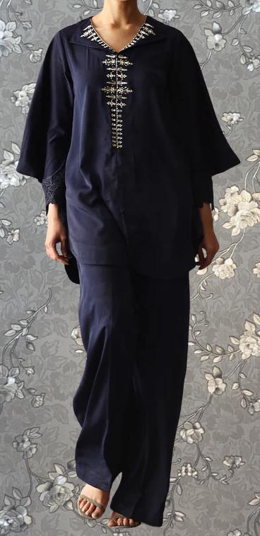 A person wearing a navy blue dress with a floral pattern and a high collar.