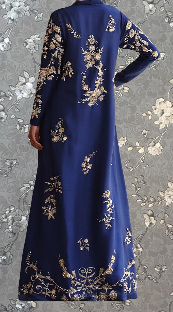 a long, blue dress with intricate gold embroidery on the back.