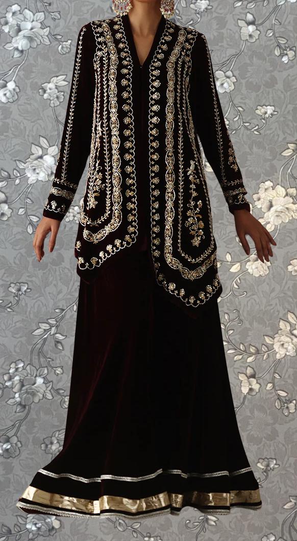 A woman wearing a long, black dress with intricate gold embroidery and a matching jacket.