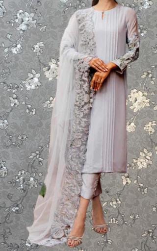 A woman wearing a long, gray dress with a sheer, lace-like skirt and a matching sheer, gray shawl draped over her shoulders.