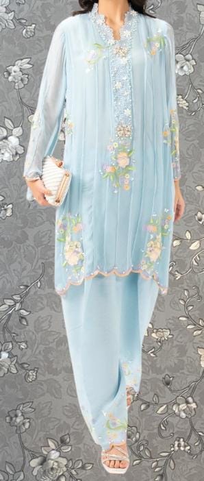 A woman wearing a light blue dress with floral embroidery and holding a small white clutch purse.